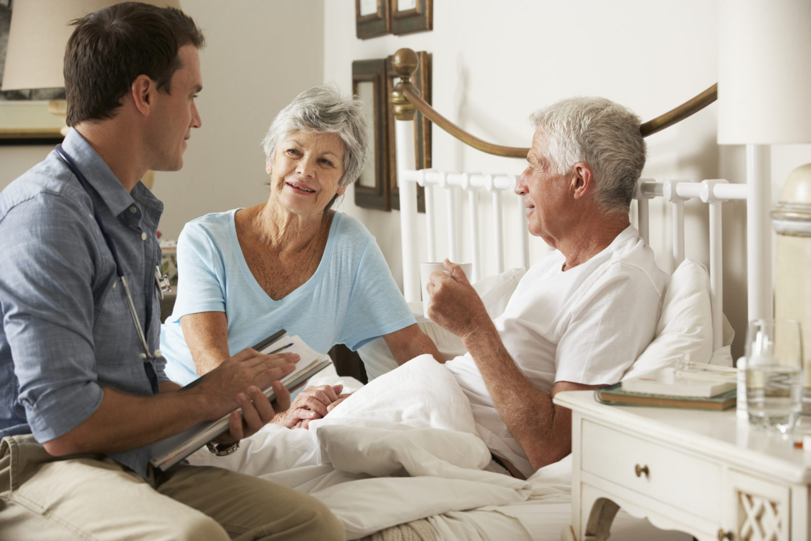 male hospice patient with doctor and wife discussing plan of care